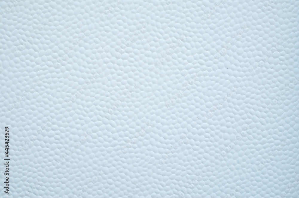 White decorative plastic surface covered with small hexagons close White decorative plastic surface covered with small hexagons close