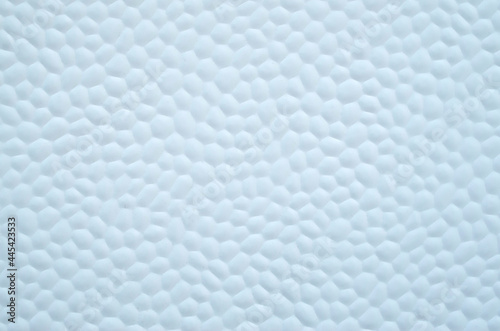 White decorative plastic surface covered with small hexagons close © isabela66
