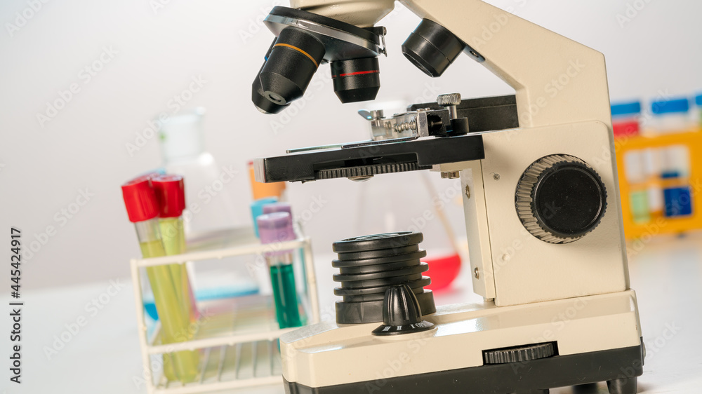 Test tubes and flasks and microscope in a chemical laboratory Test tubes and flasks and microscope in a chemical laboratory