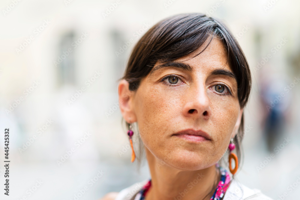Closeup portrait of a beautiful woman with serious expression on her face Closeup portrait of a beautiful woman with serious expression on her face