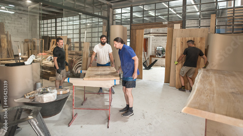 Team of carpenters making furniture in a workshop. Woodworking and crafts tools