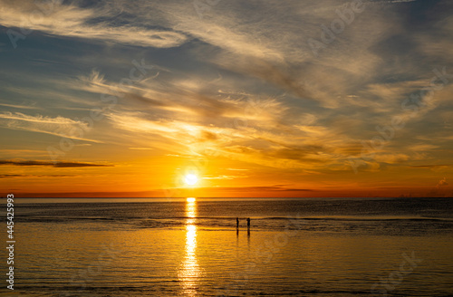 Silhouette  Tourists stand to take pictures on the beach of Hua Hin morning sunrise