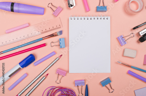 Different school supplies on light yellow background