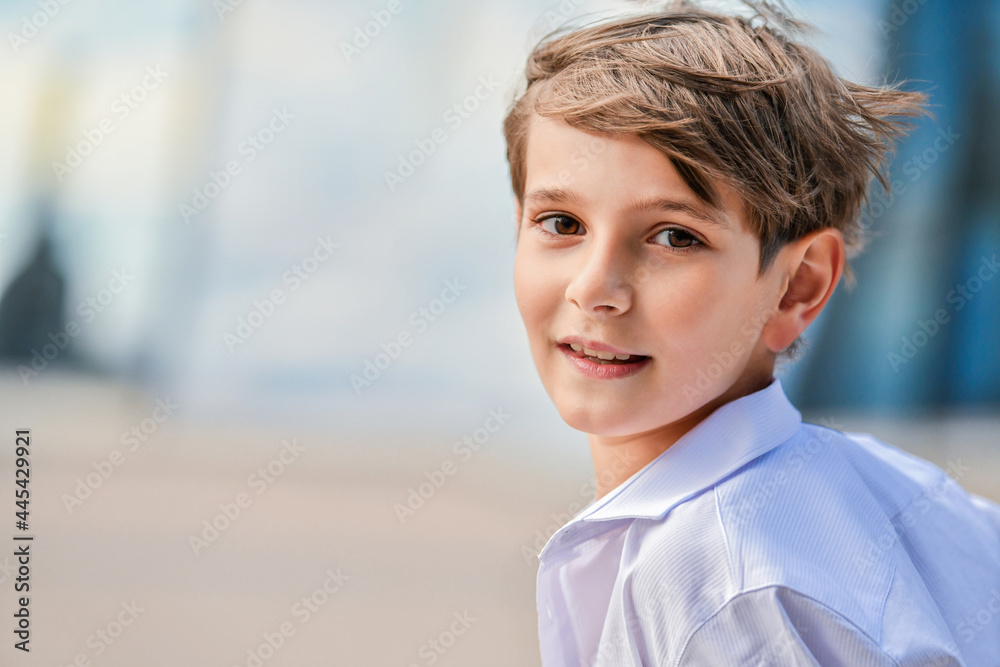 Portrait of a happy boy in an unbuttoned shirt on summer sky background Portrait of a happy boy in an unbuttoned shirt on summer sky background
