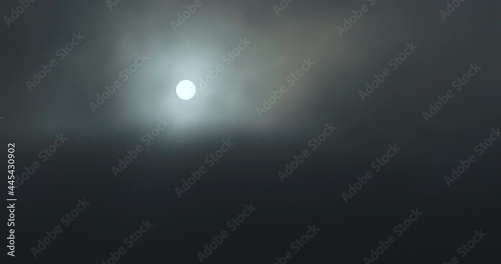 Sun covered by black clouds of smoke. Sunset over clouds. Smoke, fog. Sun covered by black clouds of smoke. Sunset over clouds. Smoke, fog.