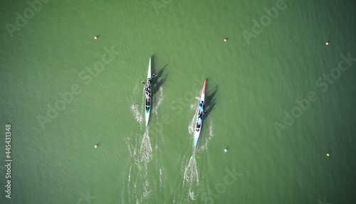 Aerial view of two boats sculling across rowing canal