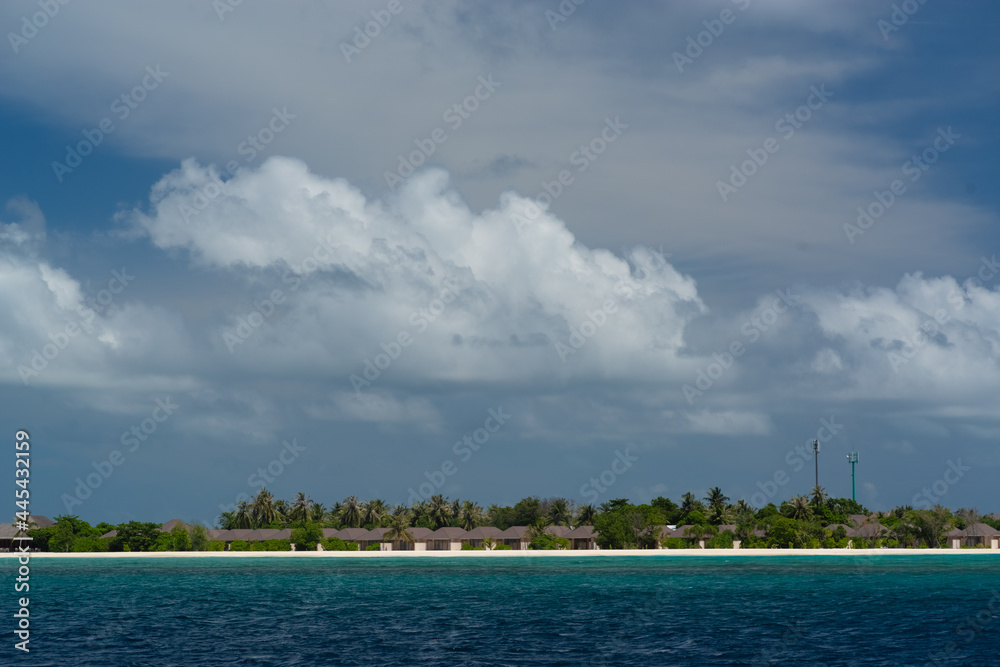 magnificent view of the coral island with a white sandy beach and dense vegetation