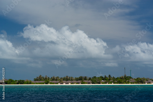 magnificent view of the coral island with a white sandy beach and dense vegetation © vosik68