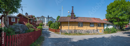 Photography Road crossing with old tree houses in the old district town Vaxholm in Stockholm
