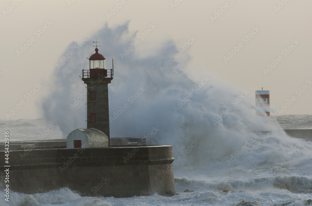 ocean waves crashing into the lighthouse