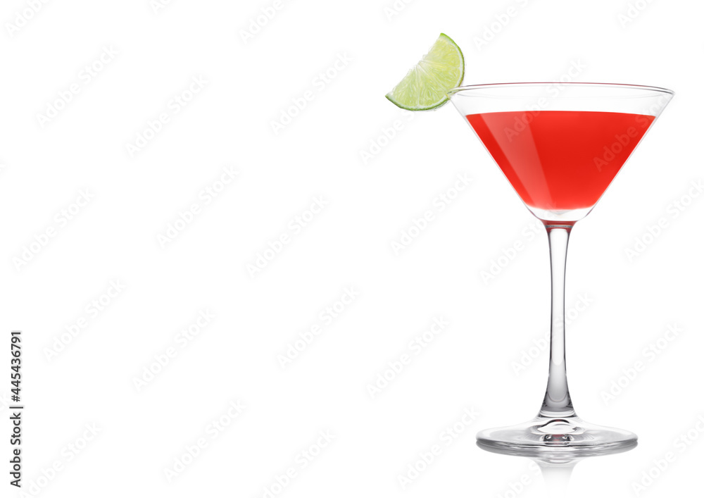 Cosmopolitan cocktail in classic crystal glass with lime slice on white.