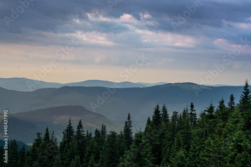 sunset in the mountains with distant mountains silhouettes © EvhKorn