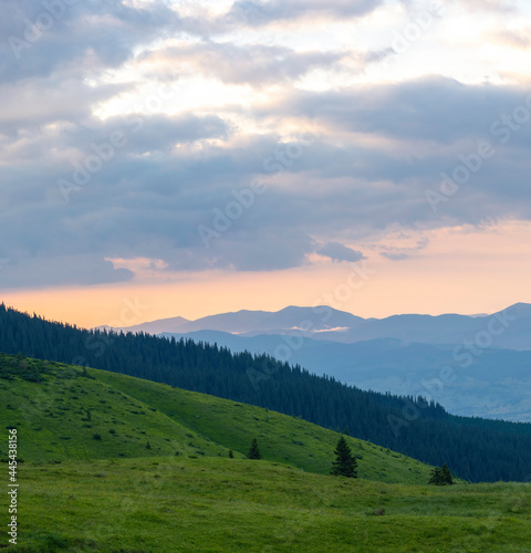 sunset in the mountains with distant mountains silhouettes