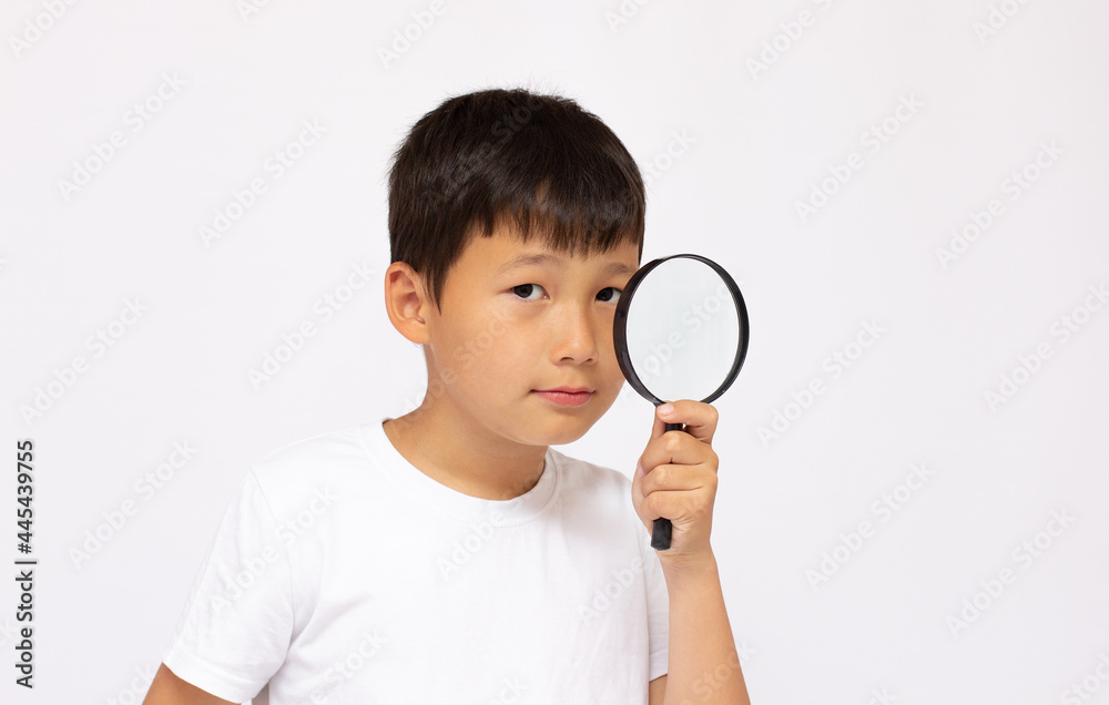 Children development, education concept. Child looking through a magnifying glass loop, closeup Children development, education concept. Child looking through a magnifying glass loop, closeup