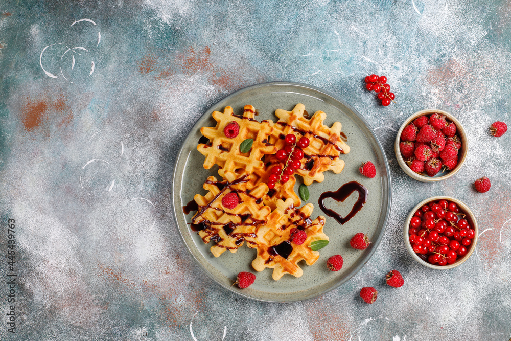 Homemade waffles with raspberries and red currants.