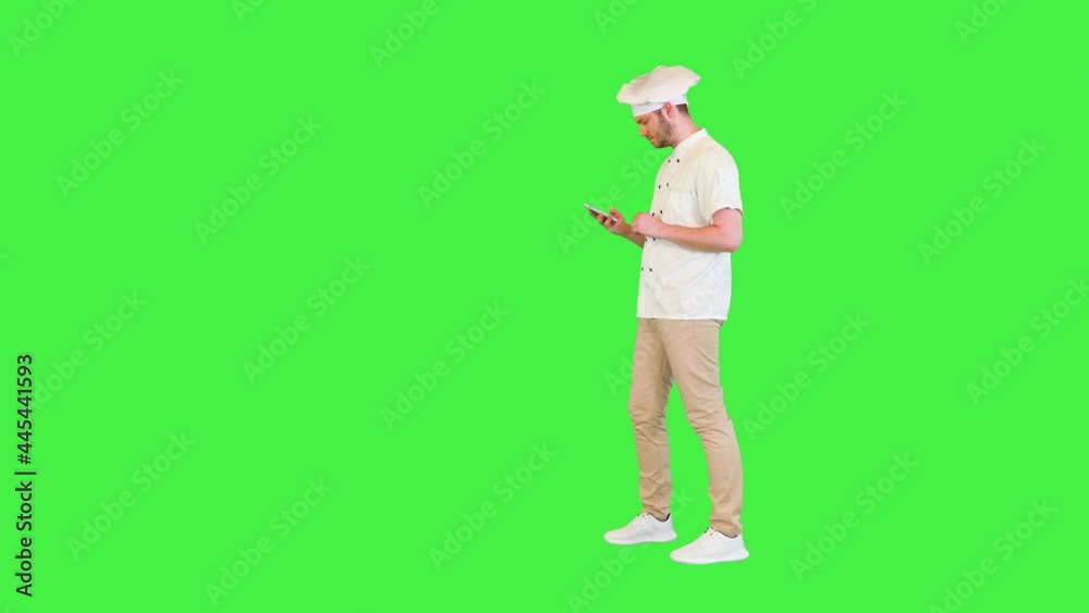 Busy professional chef with smartphone order ingredients for cooking to restaurant online walking on a Green Screen, Chroma Key. Busy professional chef with smartphone order ingredients for cooking to restaurant online walking on a Green Screen, Chroma Key.