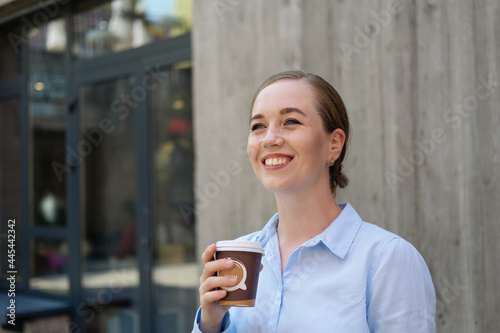 happy confident business woman drinking coffee stand in city 