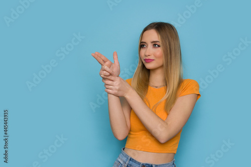 Young Woman Is Aiming With Pistol Fingers