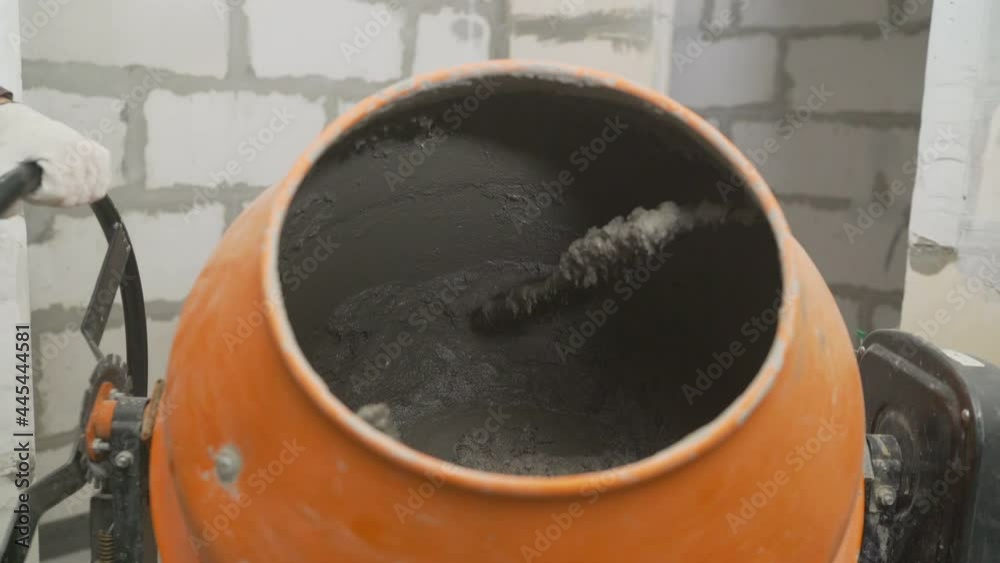 Mixing of concrete in a concrete mixer. Mortar in a concrete mixer. Mixing of concrete in a concrete mixer. Mortar in a concrete mixer.