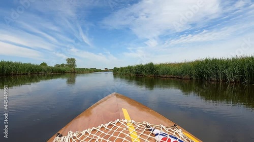 Canoeing on a quiet canal towards Oudega in Friesland, The Netherlands photo