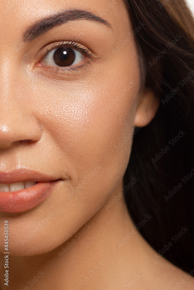 Close-up portrait of a beauty woman with full lips, straight hair and perfectly clean skin. Daytime makeup, styling and soft care. Skin care in the spa salon or cosmetology, smooth eyebrows