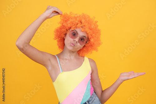 funny kid in sunglasses presenting product, copy space, advertising.