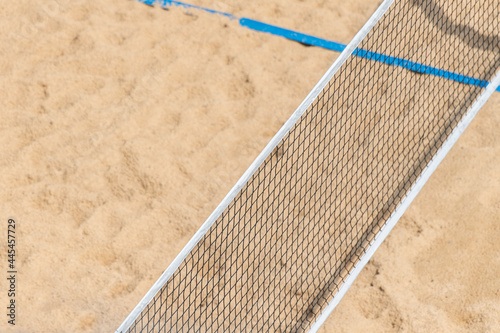 Beach volleyball and beach tennis net on the background of sand. Summer sport concept photo