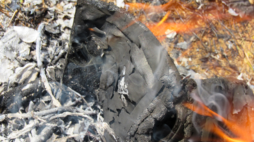 A smoldering document in the flames of fire A smoldering document in the flames of fire
