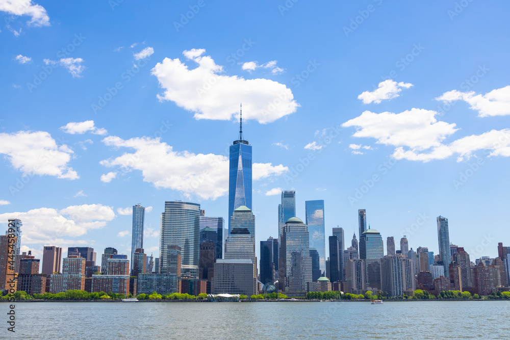 Unique shape clouds float over the Lower Manhattan skyscraper in springtime at New York City NY USA on May 14 2021. Image was taken from Jersey City NJ.