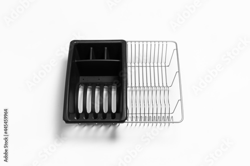 Stainless steel cutlery and dish drainer isolated on white background. High-resolution photo.