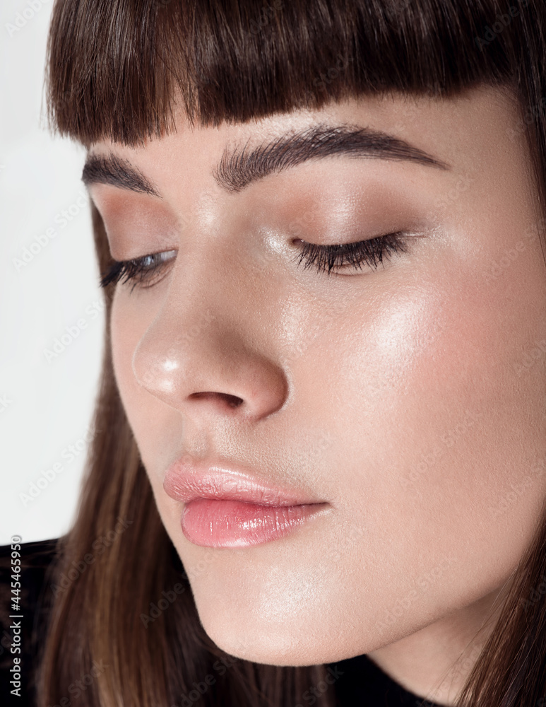 Obraz premium Beauty woman portrait. Beautiful spa model girl with perfect fresh clean skin. Bushy eyebrows. Youth and skin care concept. White background. Nude makeup