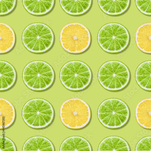 Seamless pattern with lime and lemon on a green background. Tropical abstract background. Top view, flat lay.