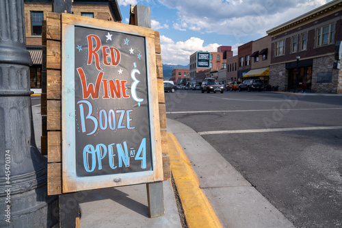 Livingston, Montana - July 3, 2021: Handwritten chalkboard sign for a restaurant celebrating the Fourth of July, opening at 4 photo
