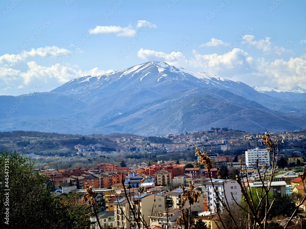A Blue Mountain with the Snowy Top Surrounded by the City of L'Aquila, Abruzzo, Italy