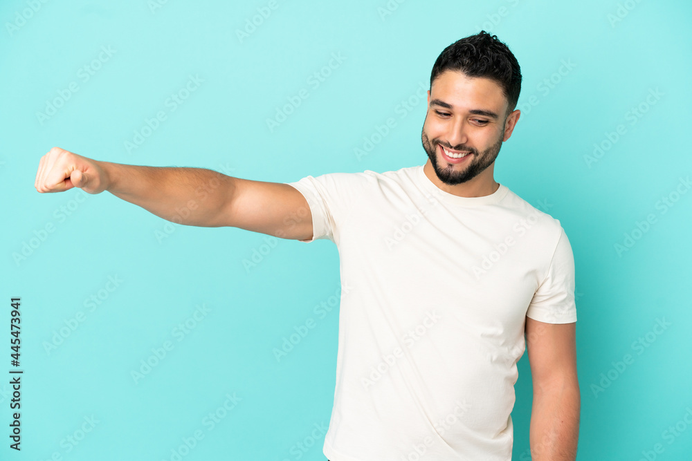 Young arab man isolated on blue background giving a thumbs up gesture Young arab man isolated on blue background giving a thumbs up gesture