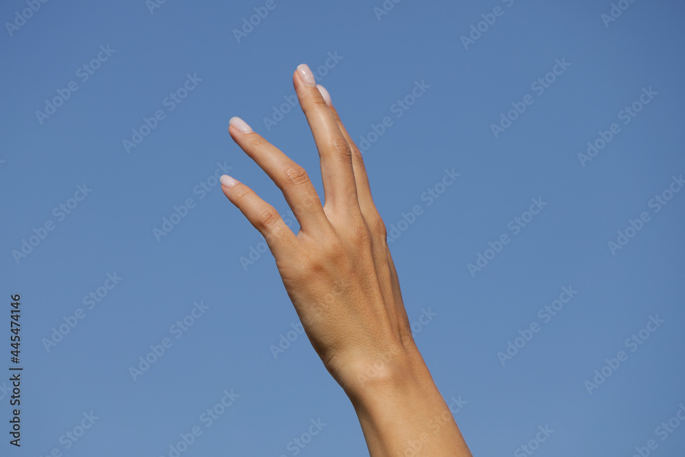 hands on sky background. Sensual woman hand. Cream. Spa. Beauty hands on sky background. Sensual woman hand. Cream. Spa. Beauty