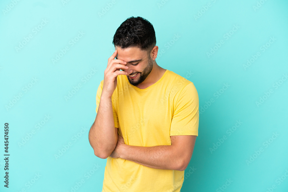 Young arab man isolated on blue background laughing Young arab man isolated on blue background laughing