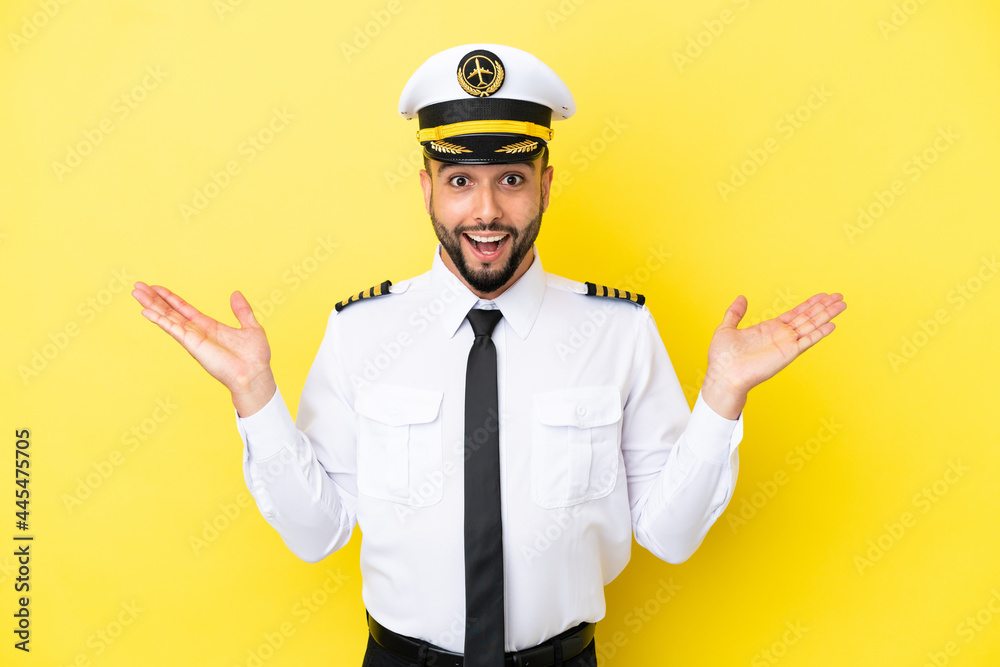 Airplane arab pilot man isolated on yellow background with shocked facial expression