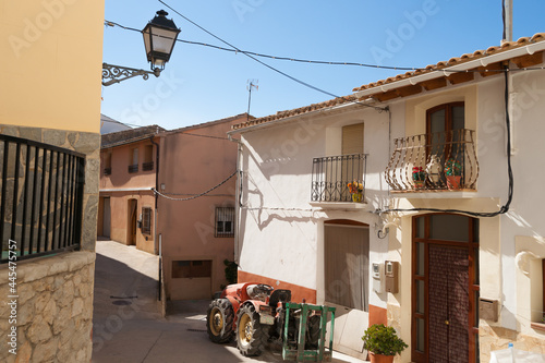 Tractor parked in very tidy street in small mountain town Tarbena, Spain photo