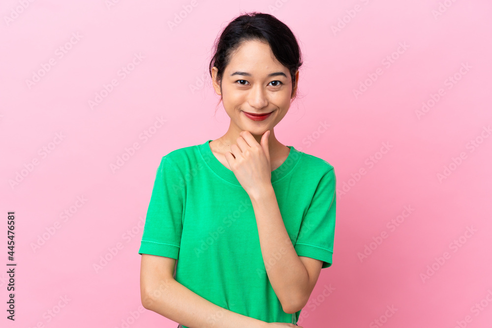 Young Vietnamese woman isolated on pink background thinking an idea while looking up Young Vietnamese woman isolated on pink background thinking an idea while looking up