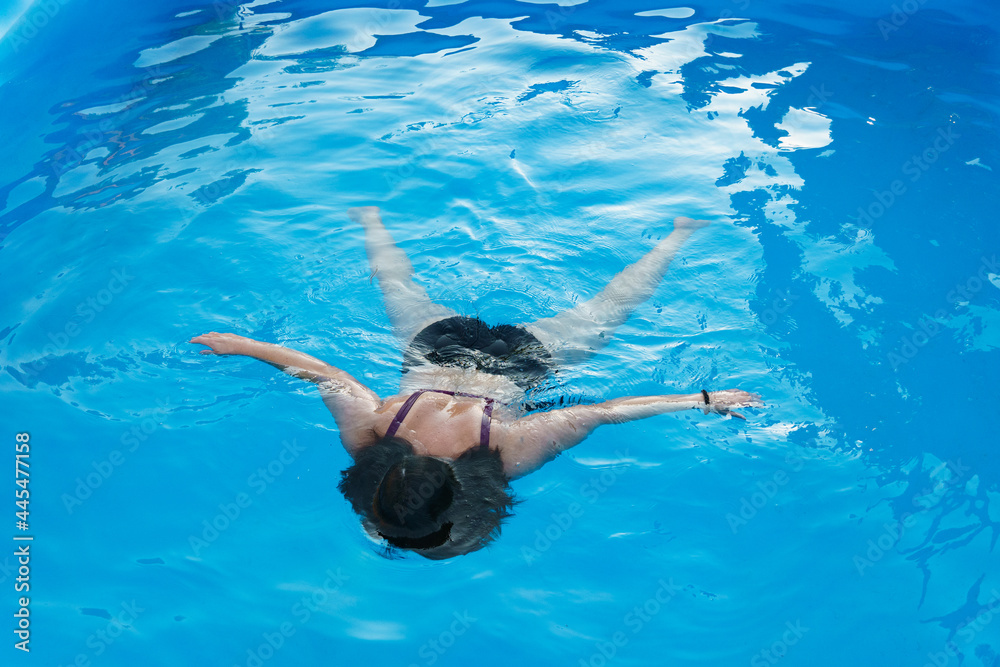 Girl drowning in the pool. Girl in danger in water