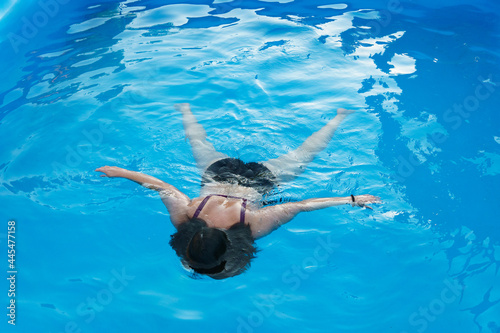 Girl drowning in the pool. Girl in danger in water
