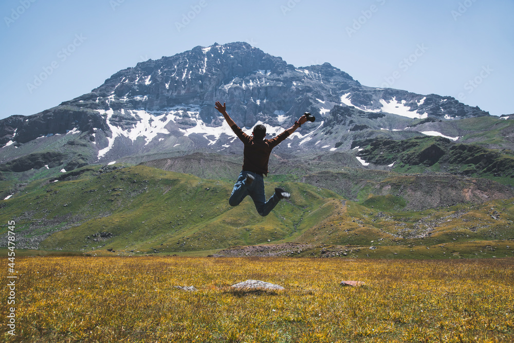 custom made wallpaper toronto digitalThe hiker jump after climbing.  Beautiful  alpine clear lake and mountains. Volcano mountain Aragats Armenia