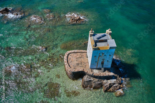 Aerial drone image of Seymour Tower at high tide in the sunshine. Jersey Channel Islands.