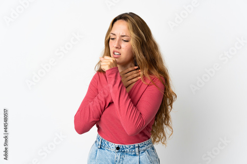 Young blonde woman isolated on blue background coughing a lot