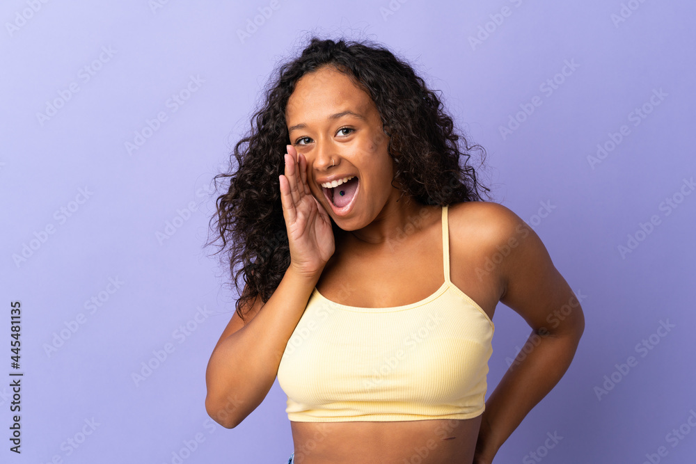 Teenager cuban girl isolated on purple background shouting with mouth wide open