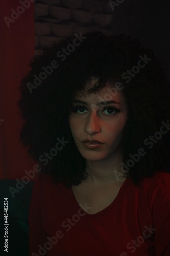 young curly hair woman smoking at night