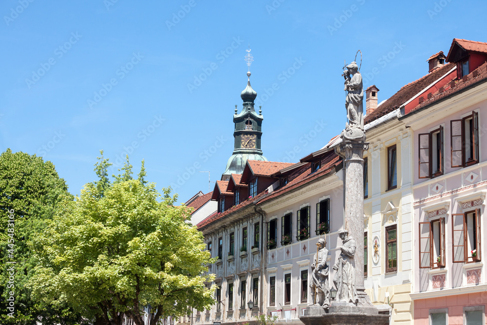Obraz premium Panorama of Mestni trg, the main square of Skofja loka, Slovenia, with the city hall, obcina, a 18th century marian column and facades of typical baroque buildings from Austro Hungary. ..