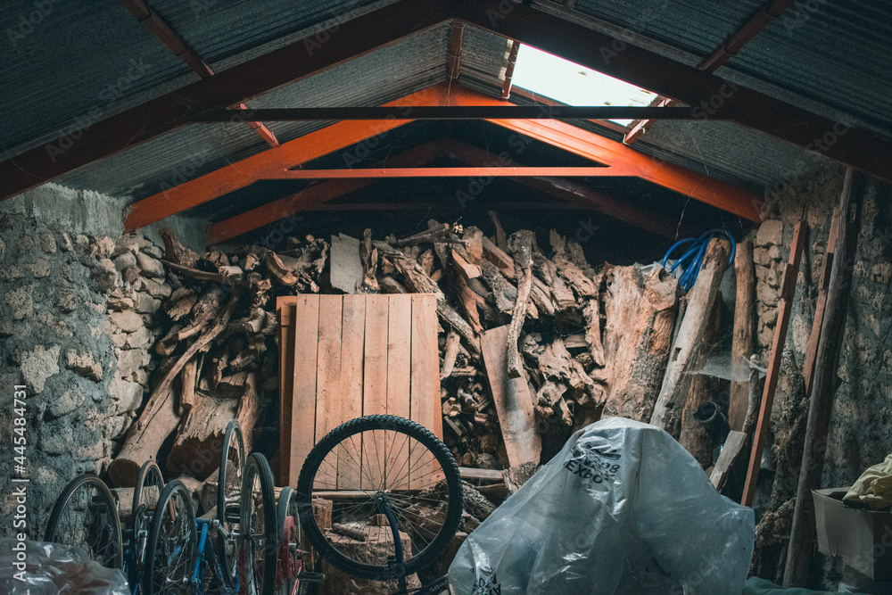 Old wooden shed with equipment and bikes - obrazy, fototapety, plakaty 