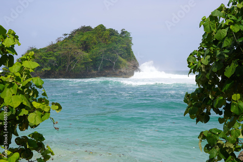 Landscape of the Teluk Asmara Beach surrounded by hills and greenery in Indonesia photo
